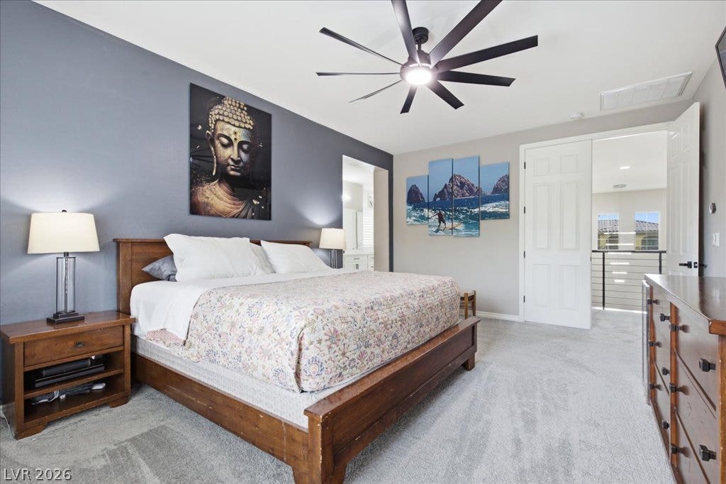 181 Elder View Drive, Las Vegas, NV 89138 A tranquil bedroom provides comfort with soft carpeting and a modern ceiling fan for optimal airflow.