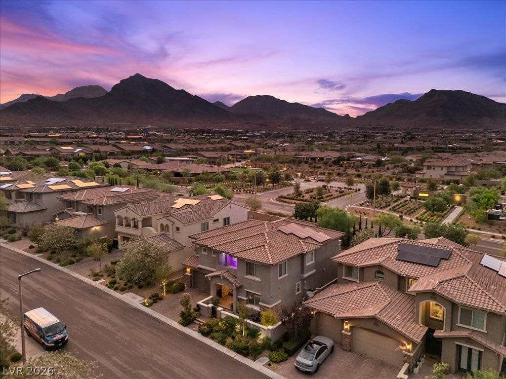 181 Elder View Drive, Las Vegas, NV 89138 Majestic mountain ridges frame a peaceful residential enclave under a colorful twilight sky.