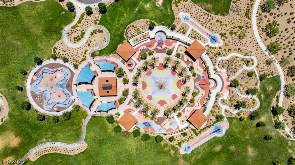 181 Elder View Drive, Las Vegas, NV 89138 An aerial perspective reveals a vibrant community playground, complete with green spaces and walking paths.
