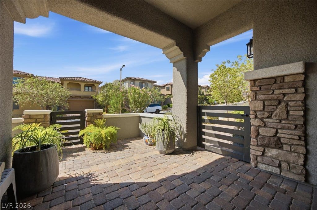 181 Elder View Drive, Las Vegas, NV 89138 An inviting gated courtyard features stone accents and interlocking paver flooring under a shaded entry.