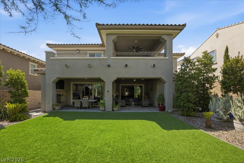 181 Elder View Drive, Las Vegas, NV 89138 An inviting covered patio opens directly onto a manicured green lawn.