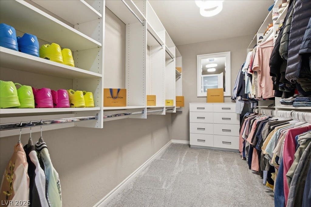 181 Elder View Drive, Las Vegas, NV 89138 Ample storage solutions define this well-appointed walk-in closet, maximizing organization with custom shelving and hanging space.