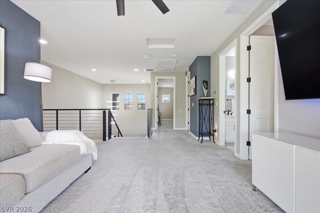 181 Elder View Drive, Las Vegas, NV 89138 A spacious upper-level living area features a modern stair railing and recessed lighting throughout.