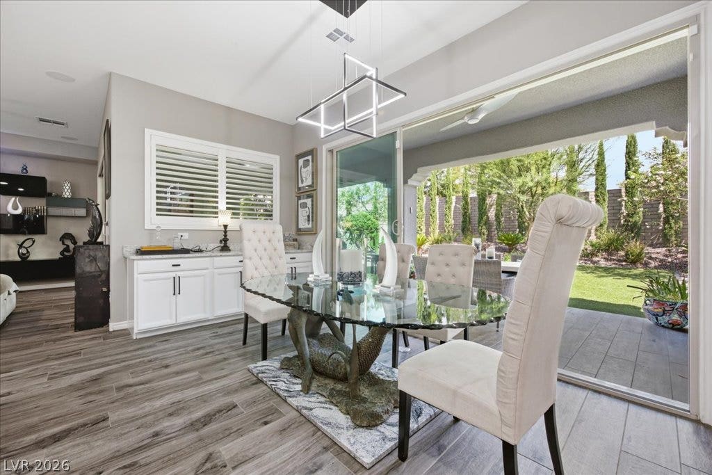 181 Elder View Drive, Las Vegas, NV 89138 A spacious dining area with wood-look flooring transitions seamlessly to the covered patio beyond.