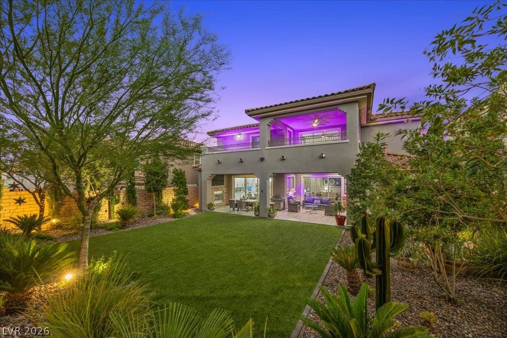 181 Elder View Drive, Las Vegas, NV 89138 Mature trees and desert landscaping frame this multi-level stucco home with a covered rear patio.