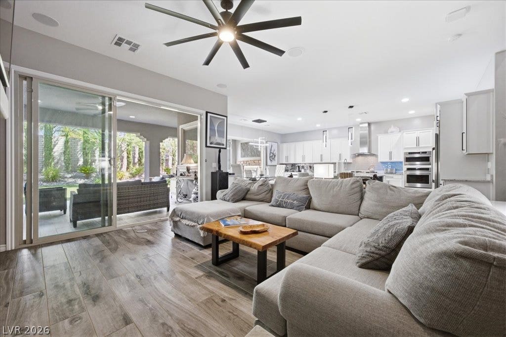 181 Elder View Drive, Las Vegas, NV 89138 A spacious open-concept interior flows seamlessly through wide sliding glass doors to the patio.