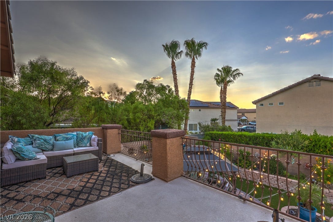 10474 Rustyville Court, Las Vegas, NV 89129 An inviting balcony with an ornate railing offers a panoramic view of the neighborhood at sunset. Enough space to have a couch.