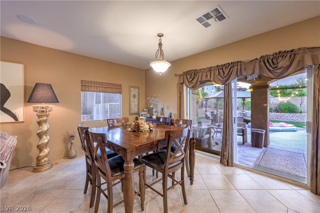 10474 Rustyville Court, Las Vegas, NV 89129 This warm dining room with tiled flooring flows seamlessly to an inviting outdoor living space.