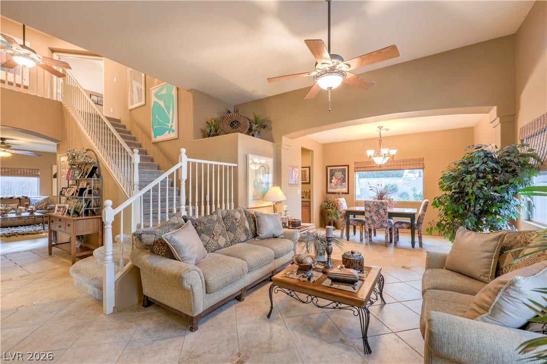 10474 Rustyville Court, Las Vegas, NV 89129 This inviting home features soaring ceilings, a sweeping staircase, and a seamless flow between living and dining areas.