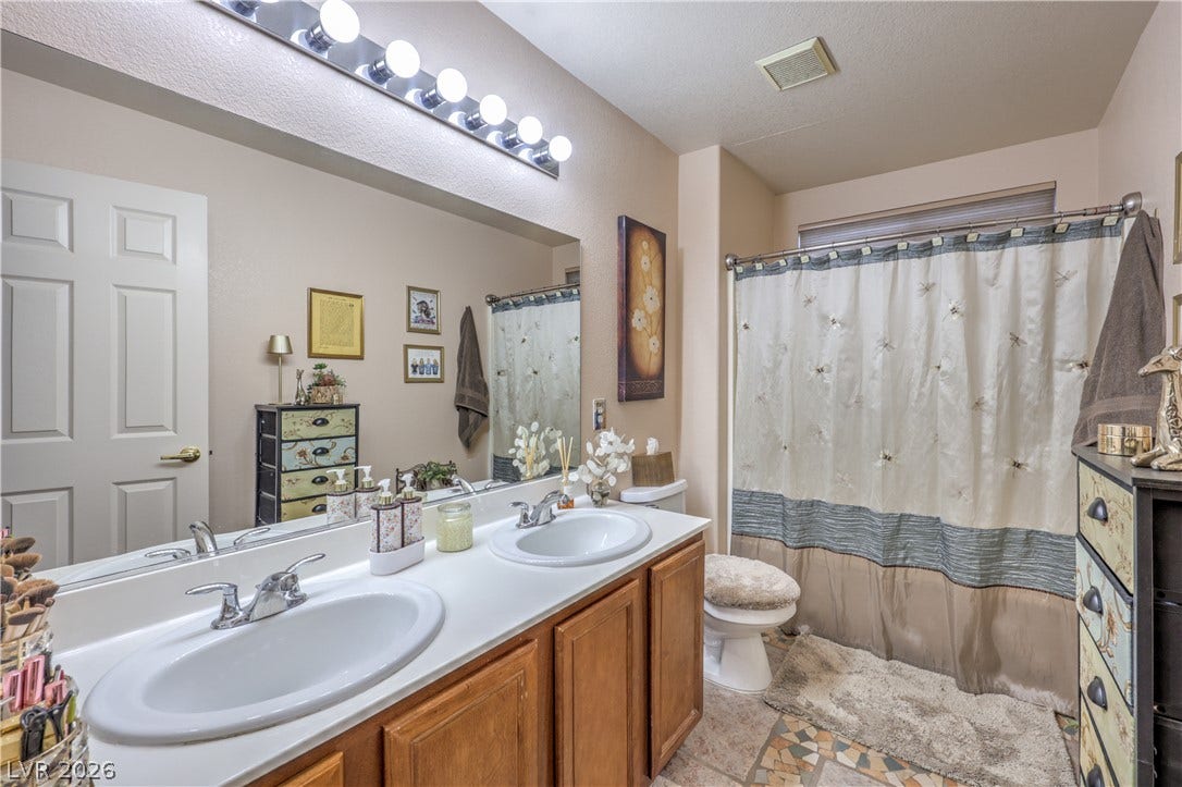 10474 Rustyville Court, Las Vegas, NV 89129 Double vanity in this hall bathroom offers ample counter space for daily routines.