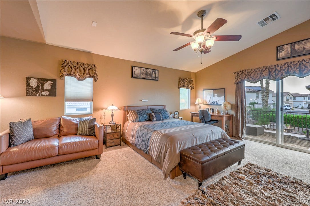 10474 Rustyville Court, Las Vegas, NV 89129 The inviting primary bedroom features vaulted ceilings and direct access to a private balcony.