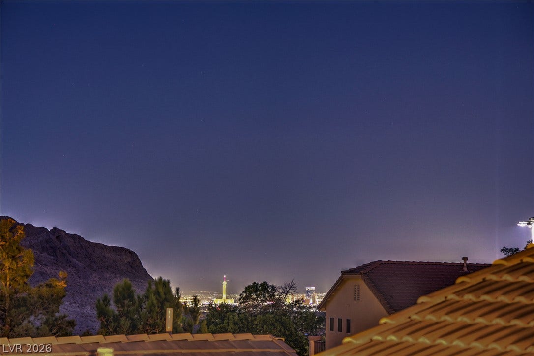 10474 Rustyville Court, Las Vegas, NV 89129 Dramatic night vistas showcase distant city lights from this hillside property.