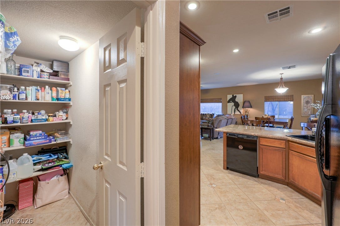 10474 Rustyville Court, Las Vegas, NV 89129 Ample storage solutions complement the seamlessly flowing kitchen and living spaces, perfect for effortless daily living.