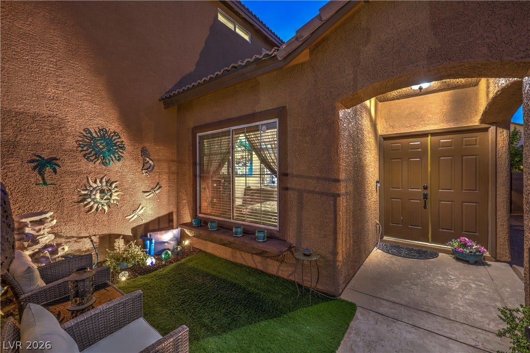 10474 Rustyville Court, Las Vegas, NV 89129 An inviting entrance with a private courtyard area, perfect for tranquil evenings.