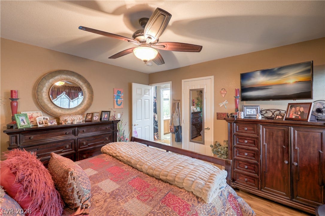 10474 Rustyville Court, Las Vegas, NV 89129 LVP flooring and a ceiling fan create a comfortable atmosphere in this well-appointed bedroom.