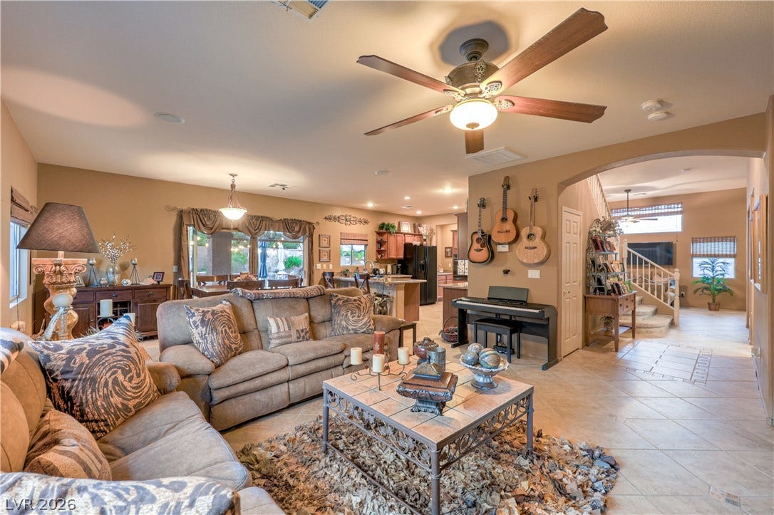 10474 Rustyville Court, Las Vegas, NV 89129 An inviting open-concept family room area flows seamlessly into the kitchen and dining space, perfect for entertaining.