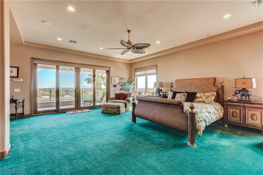 Sliding glass doors open from this expansive bedroom suite to a private balcony.