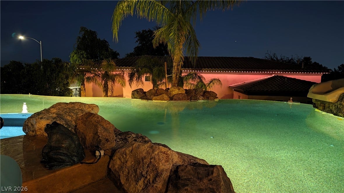 An inviting infinity pool anchors the resort-style backyard of this elegant property.