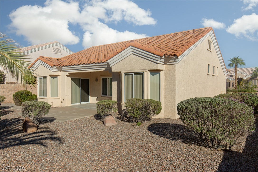 10725 Windledge Avenue, Las Vegas, NV 89134 A classic tile roof and low-maintenance desert landscaping define the rear exterior of this home.