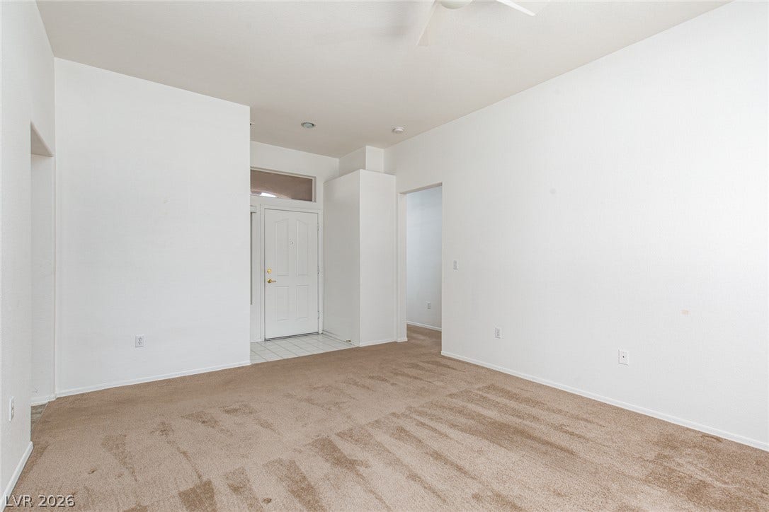 10725 Windledge Avenue, Las Vegas, NV 89134 An open entryway connects seamlessly to a carpeted living space with clean lines.