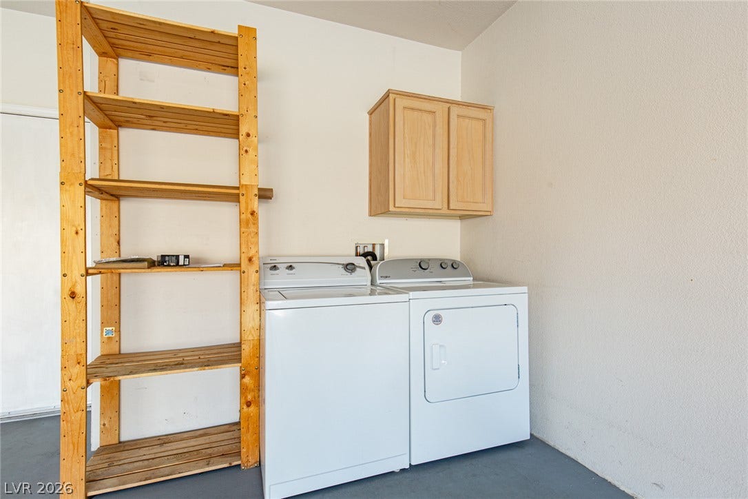 10725 Windledge Avenue, Las Vegas, NV 89134 Functional laundry utilities and built-in storage cabinets line the neat workspace.