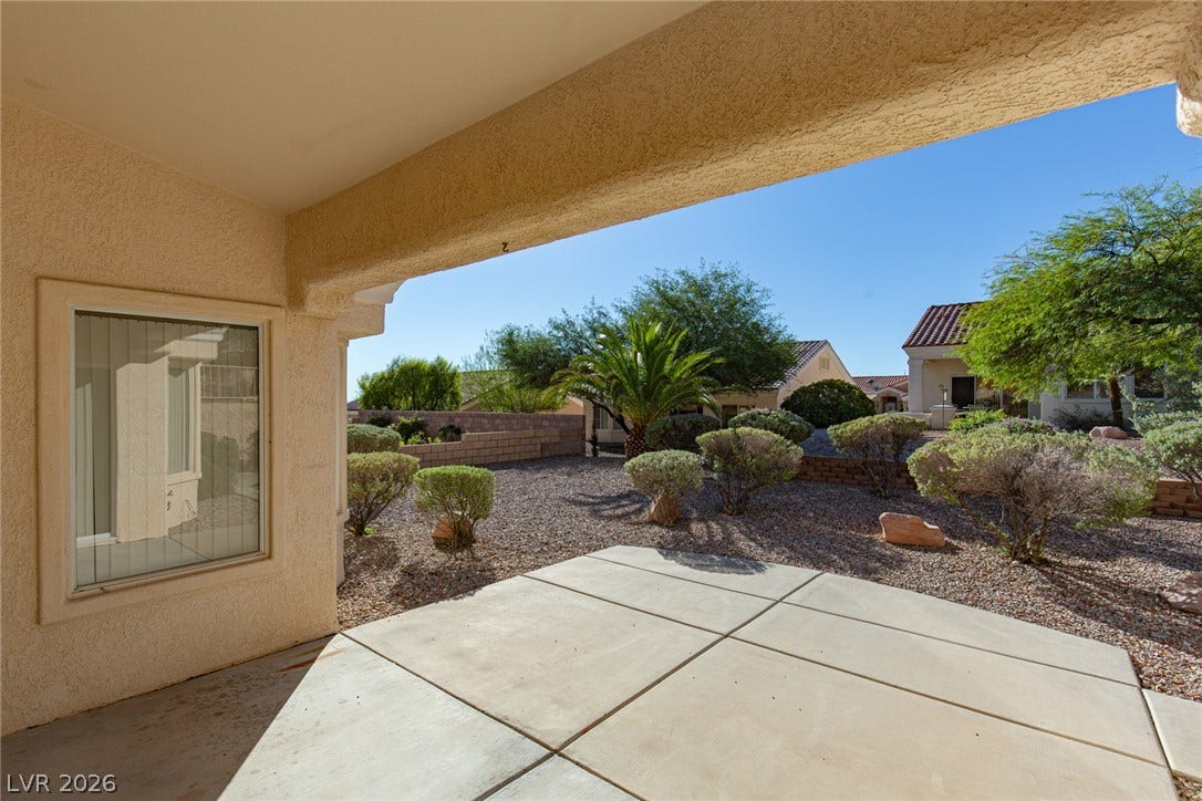 10725 Windledge Avenue, Las Vegas, NV 89134 A covered concrete patio overlooks the low-maintenance desert landscaping.