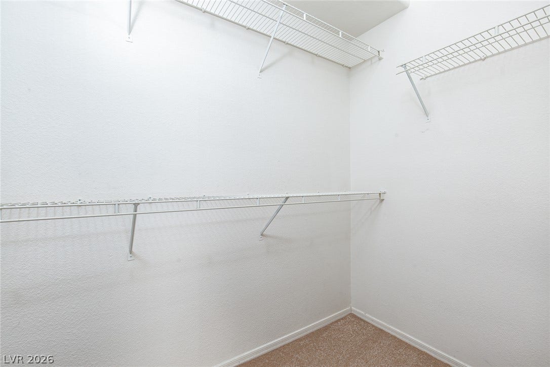 10725 Windledge Avenue, Las Vegas, NV 89134 Ample wire shelving lines this functional closet space completed by soft carpeting.