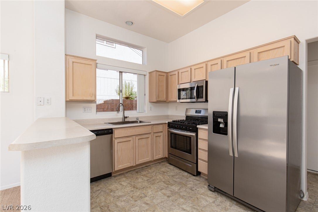 10725 Windledge Avenue, Las Vegas, NV 89134 High ceilings and tall windows bring abundant natural light into this functional kitchen.