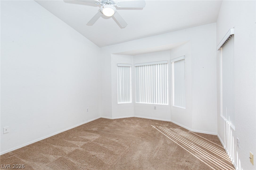 10725 Windledge Avenue, Las Vegas, NV 89134 Plentiful natural light streams through a classic bay window onto soft carpeting.