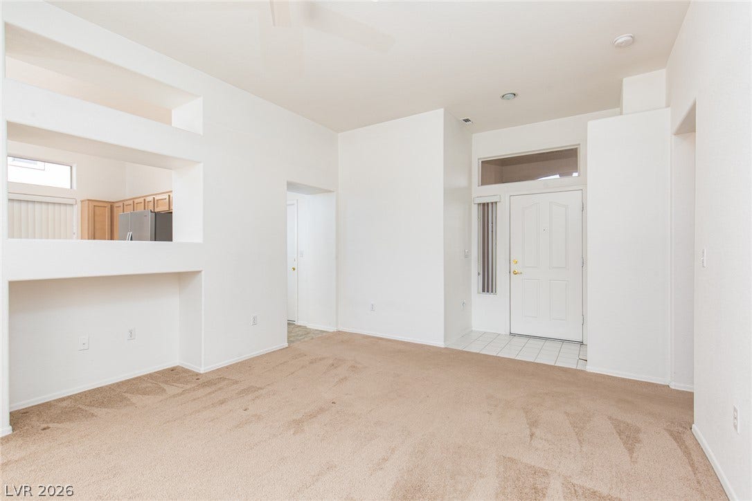 10725 Windledge Avenue, Las Vegas, NV 89134 An open floor plan connects the tiled entryway to a spacious carpeted living area.
