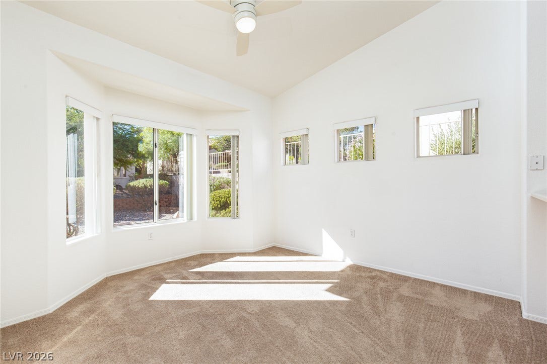 10725 Windledge Avenue, Las Vegas, NV 89134 Natural light streams through high windows over clean carpeting and vaulted ceilings.