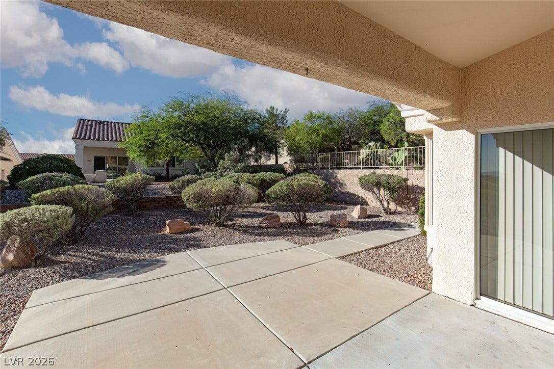 10725 Windledge Avenue, Las Vegas, NV 89134 A spacious covered patio overlooks a beautifully landscaped backyard with mature desert plantings.