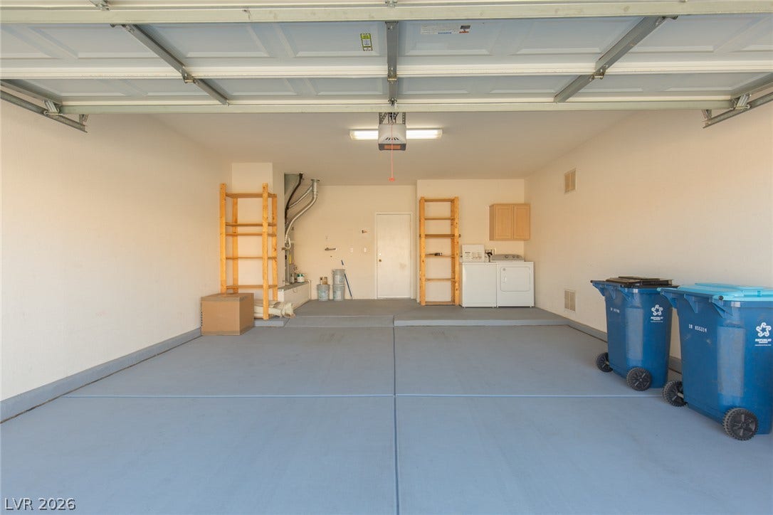10725 Windledge Avenue, Las Vegas, NV 89134 An attached garage provides finished flooring along with dedicated space for laundry utilities.
