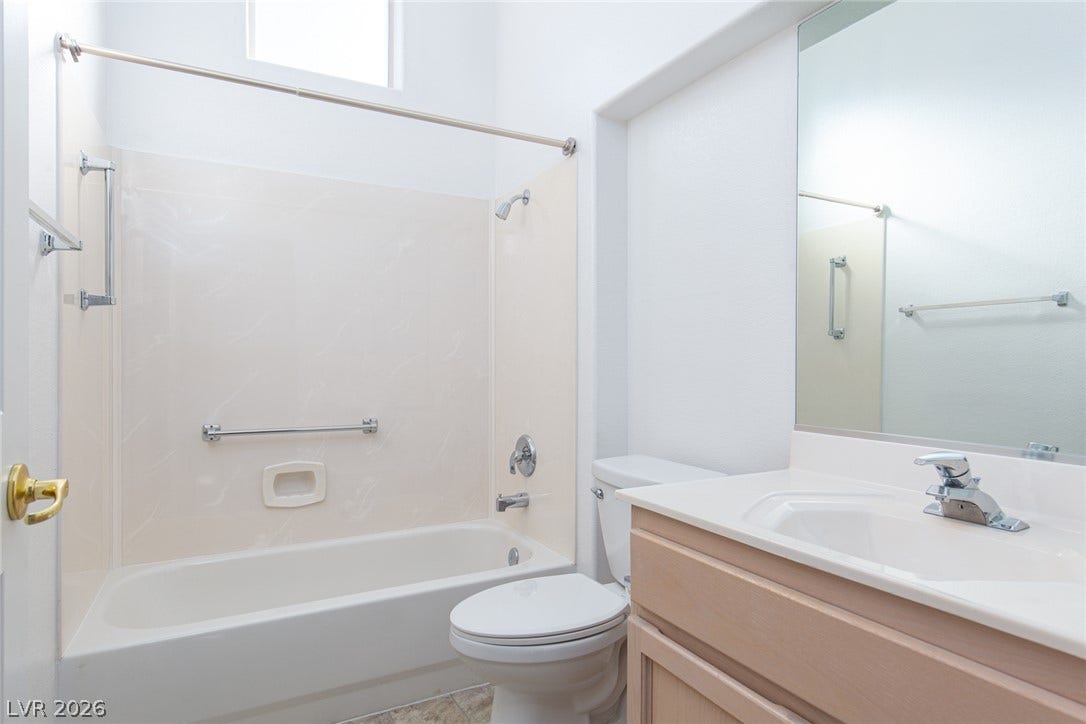 10725 Windledge Avenue, Las Vegas, NV 89134 High ceilings and a bright skylight enhance this clean, functional bathroom space.