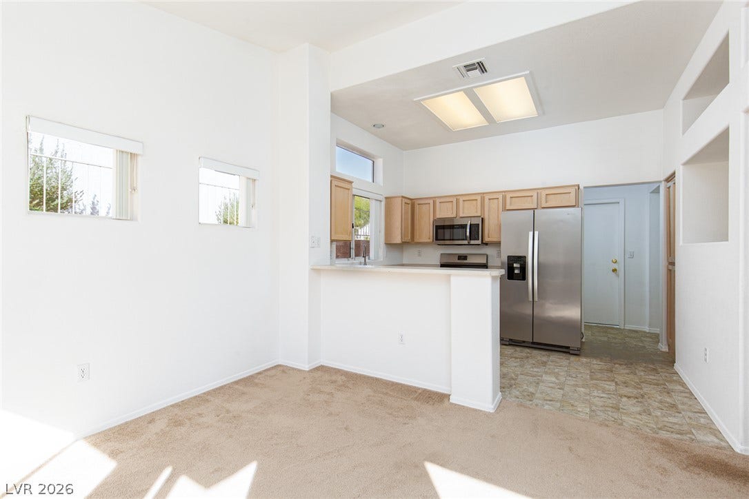 10725 Windledge Avenue, Las Vegas, NV 89134 High ceilings and an open breakfast bar seamlessly connect the kitchen to adjacent living spaces.
