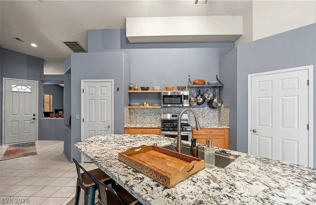 6163 Bayard Street, Las Vegas, NV 89148 High ceilings and a stone-topped island define this functional culinary space.