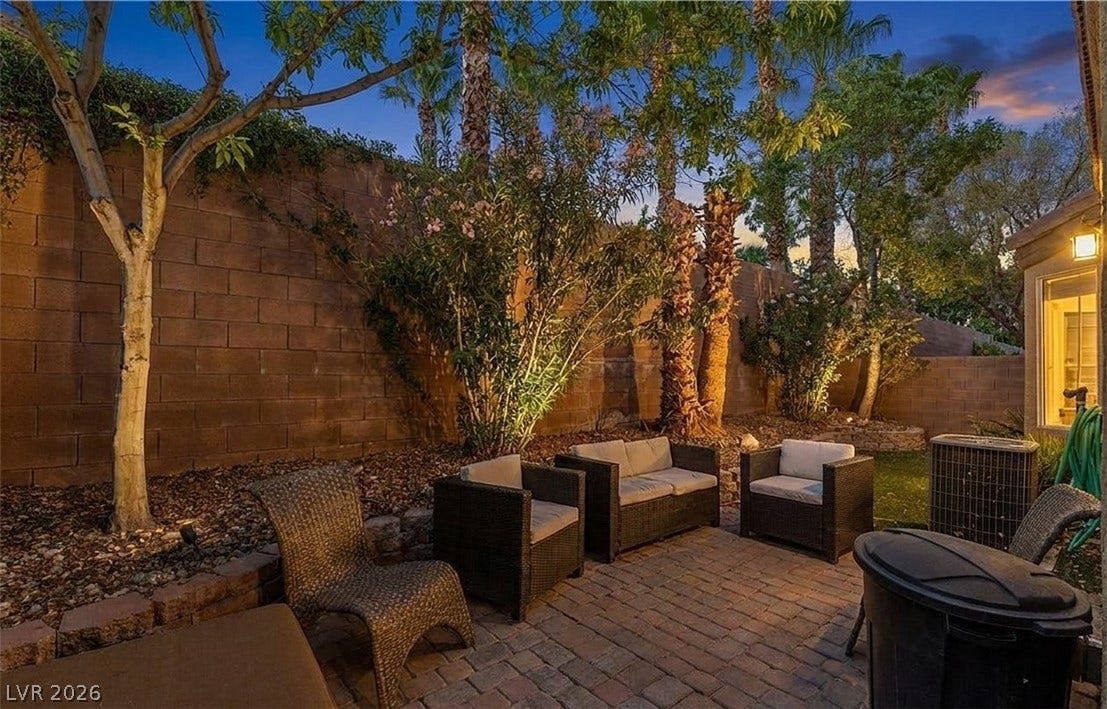 6163 Bayard Street, Las Vegas, NV 89148 Mature palms and lush foliage frame a private brick paver courtyard.