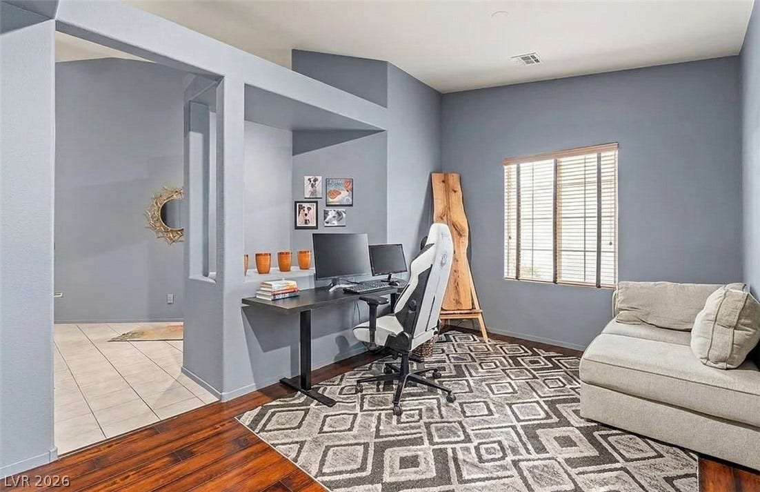 6163 Bayard Street, Las Vegas, NV 89148 Rich hardwood flooring complements the vaulted ceiling in this versatile workspace or den.