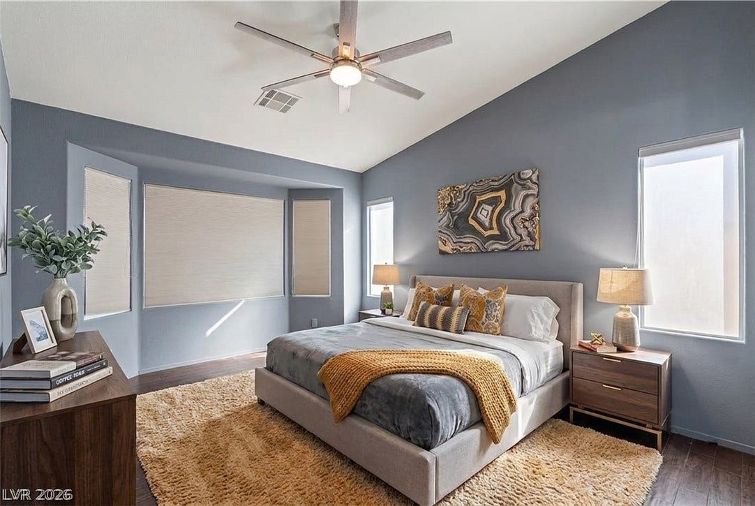 6163 Bayard Street, Las Vegas, NV 89148 Vaulted ceilings and rich wood-look flooring enhance this light-filled bedroom retreat.