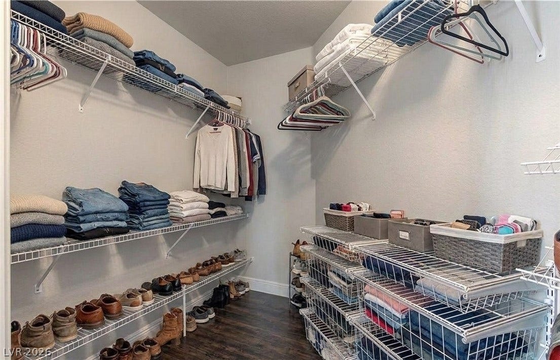 6163 Bayard Street, Las Vegas, NV 89148 Organized shelving options maximize space within this walk-in closet featuring handsome dark wood flooring.