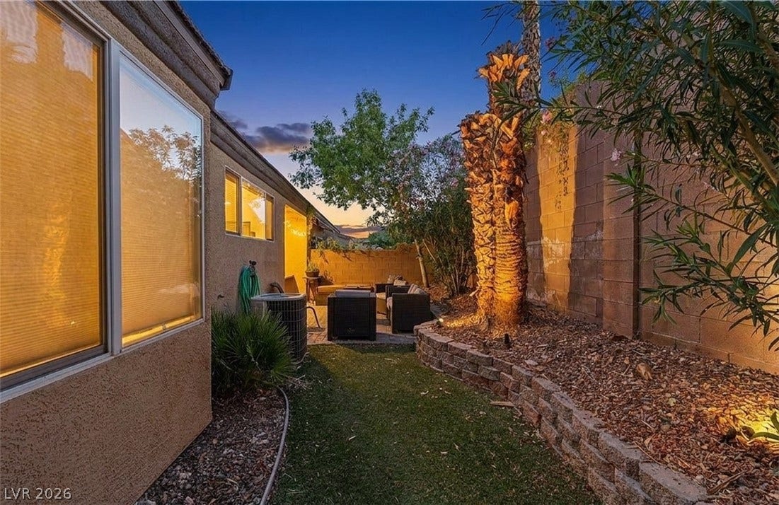 6163 Bayard Street, Las Vegas, NV 89148 Mature palms and a raised stone planter border this cozy outdoor seating area.