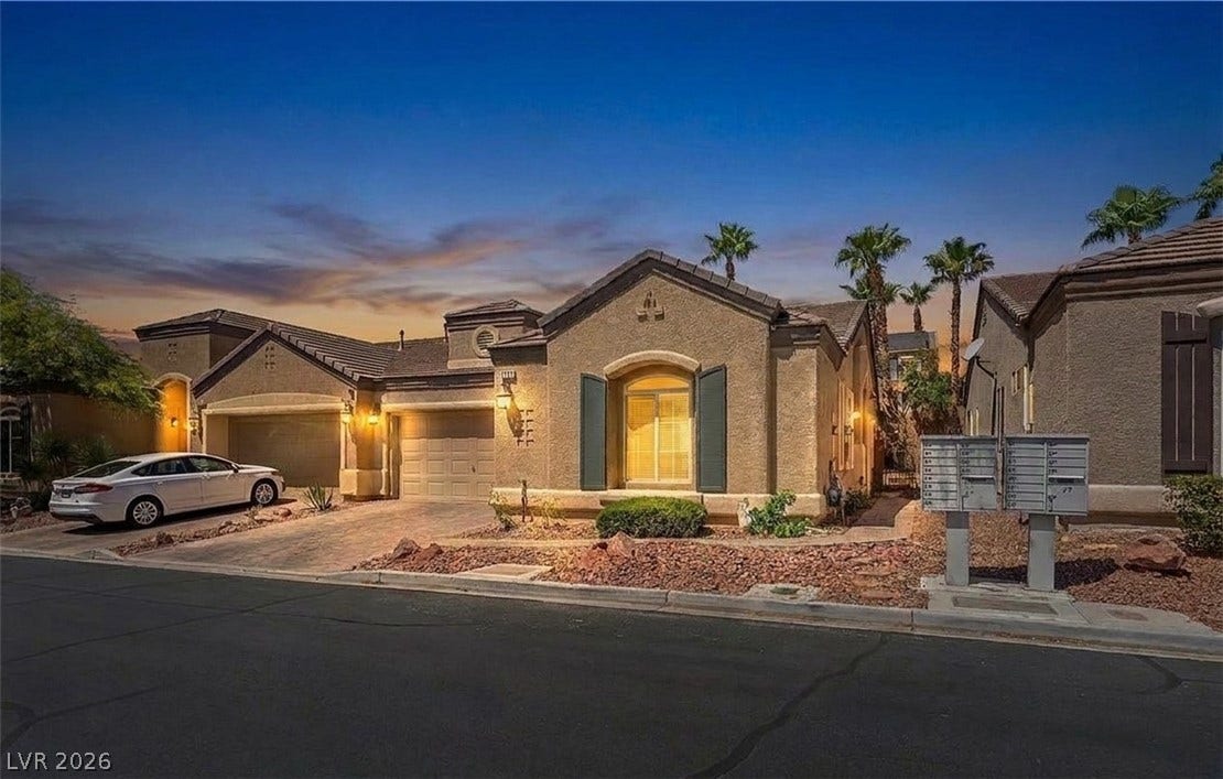 6163 Bayard Street, Las Vegas, NV 89148 Mediterranean-inspired design details complement this stucco exterior under a desert twilight sky.