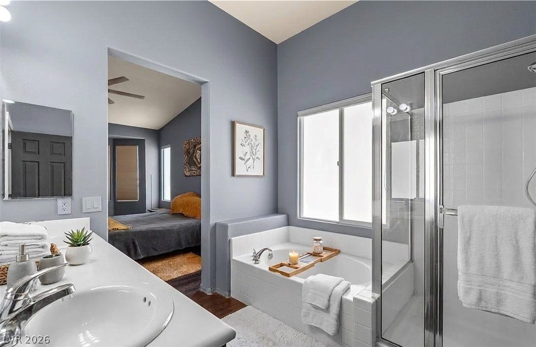 6163 Bayard Street, Las Vegas, NV 89148 An ensuite layout connects a private bath with a deep soaking tub directly to the bedroom.