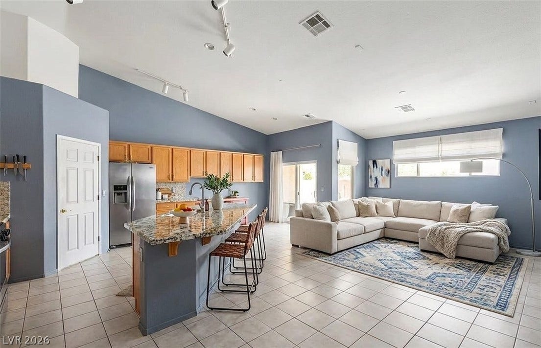 6163 Bayard Street, Las Vegas, NV 89148 Gleaming tile floors and vaulted ceilings elevate this open-concept kitchen and living area.