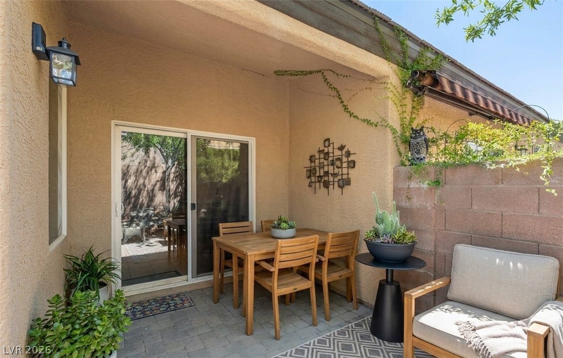 6163 Bayard Street, Las Vegas, NV 89148 An inviting covered patio features neat paver flooring alongside a privacy block wall.