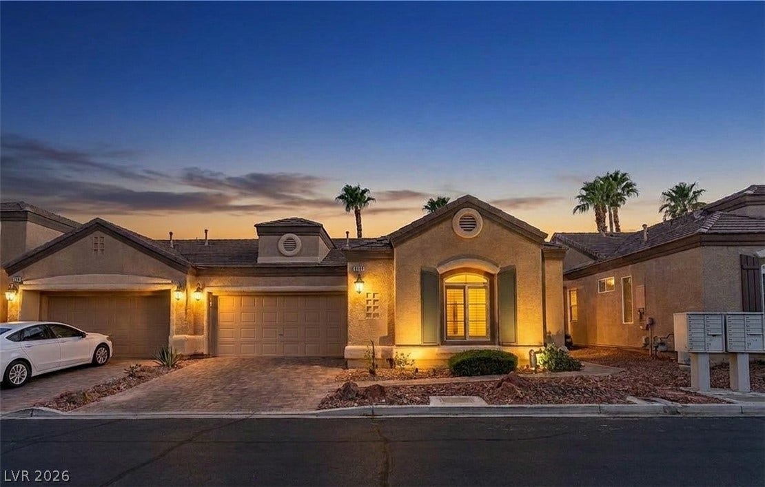 6163 Bayard Street, Las Vegas, NV 89148 Inviting exterior architectural lines glow warmly beneath a beautiful twilight sky.