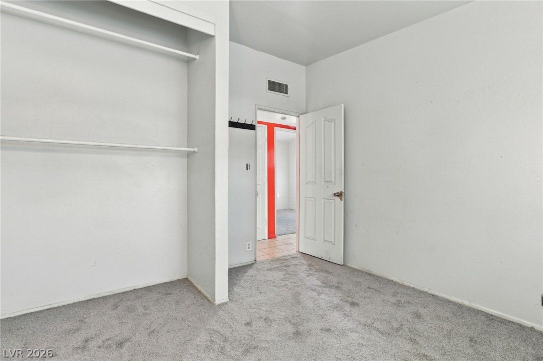 2521 Perliter Avenue, North Las Vegas, NV 89030 Plush wall-to-wall carpeting and built-in closet shelving define this versatile extra bedroom.