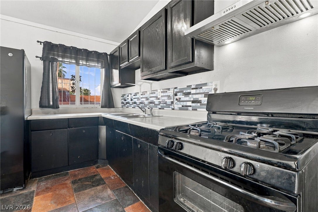 2521 Perliter Avenue, North Las Vegas, NV 89030 Bold cabinetry and patterned tile flooring create a highly functional cooking space.
