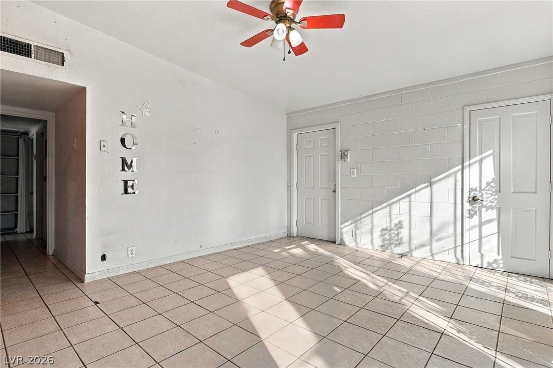 2521 Perliter Avenue, North Las Vegas, NV 89030 Tiled flooring and natural light stream through this versatile living space.