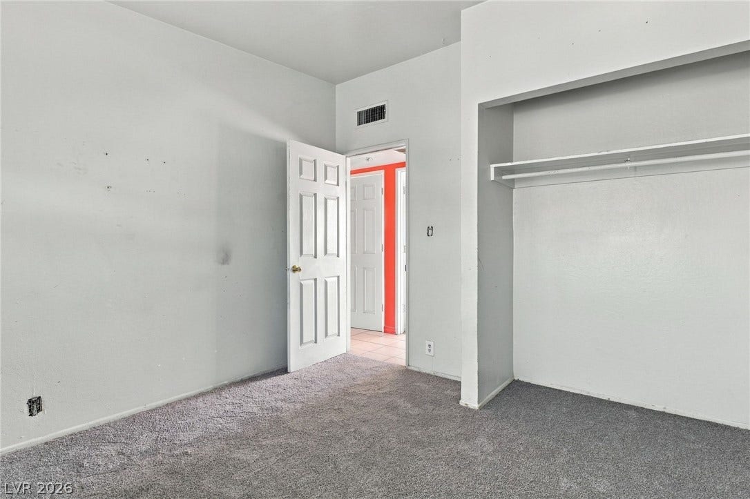 2521 Perliter Avenue, North Las Vegas, NV 89030 Plush wall-to-wall carpeting and an open closet design anchor this functional bedroom space.